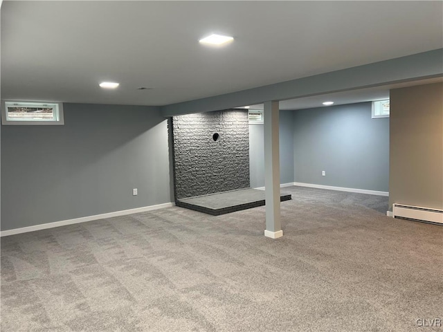 basement featuring a baseboard radiator and carpet floors