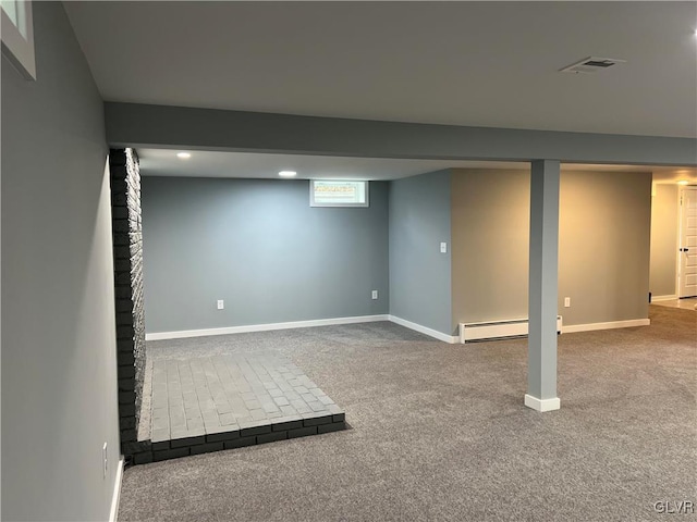 basement with carpet and a baseboard heating unit