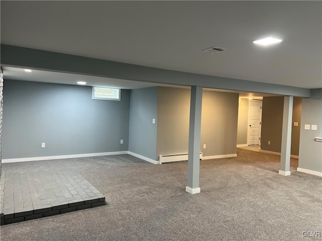 basement with carpet flooring and baseboard heating