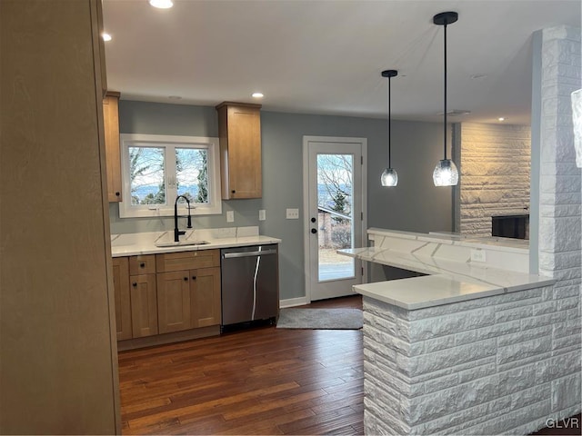 kitchen featuring sink, dark hardwood / wood-style floors, dishwasher, kitchen peninsula, and pendant lighting