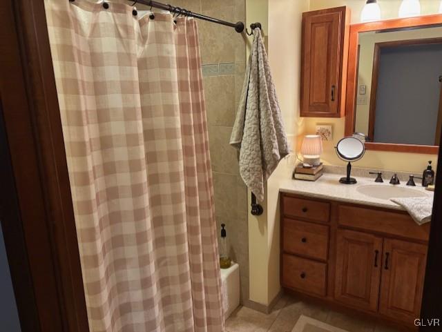 bathroom featuring tile patterned flooring, vanity, and shower / tub combo