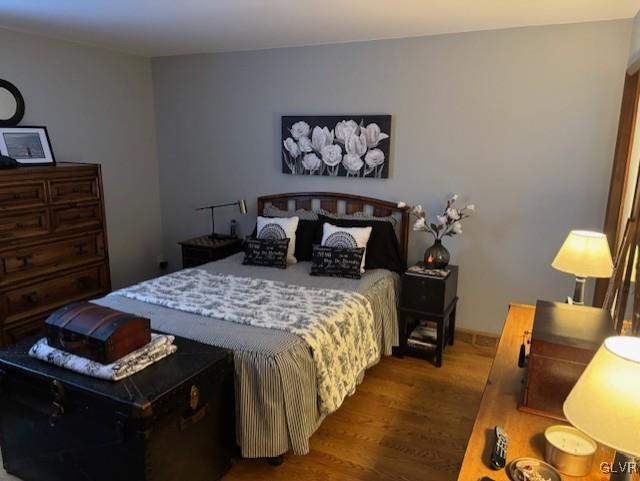 bedroom with dark wood-type flooring