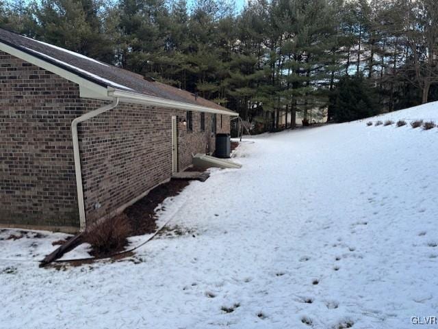 yard covered in snow with central AC unit