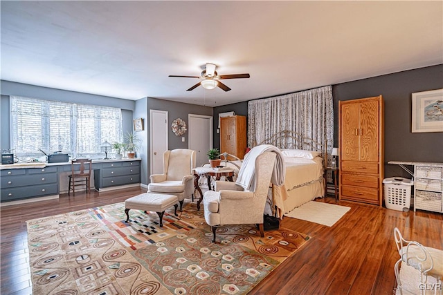 bedroom with multiple closets, dark hardwood / wood-style floors, and ceiling fan