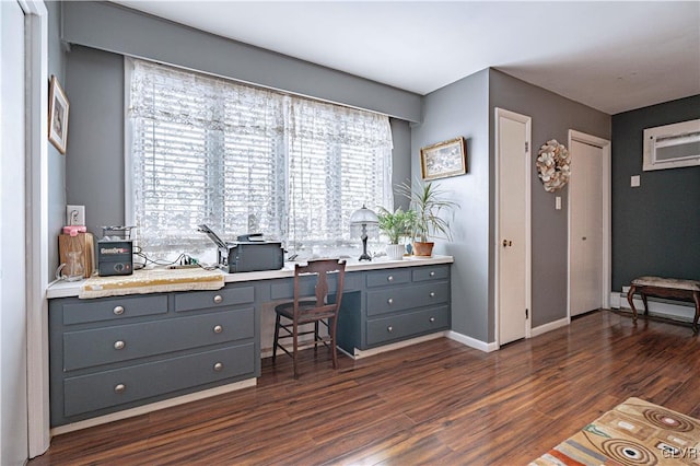 office space with a baseboard radiator, dark wood-type flooring, and a wall mounted AC