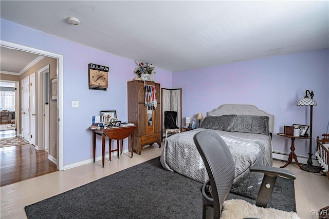 bedroom featuring crown molding, hardwood / wood-style flooring, and baseboard heating