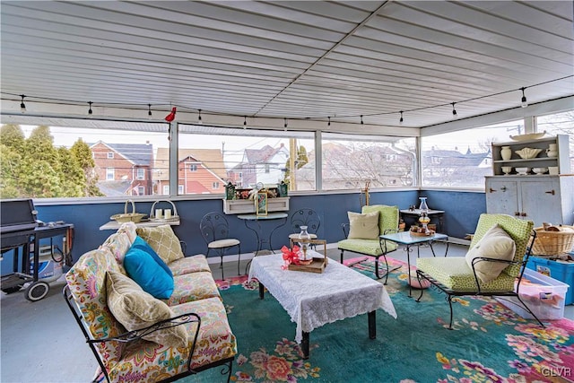 sunroom / solarium with a wealth of natural light and track lighting