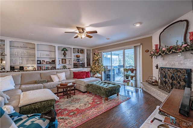 living room featuring crown molding, a fireplace, dark hardwood / wood-style flooring, and ceiling fan