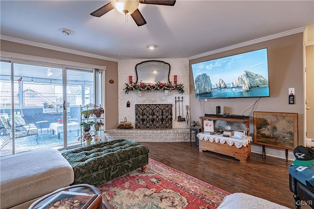 living room featuring hardwood / wood-style flooring, ornamental molding, ceiling fan, and a fireplace