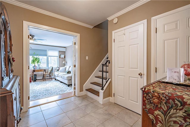 foyer featuring light tile patterned floors, ornamental molding, and ceiling fan