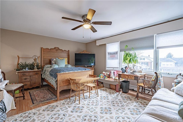 bedroom with light hardwood / wood-style flooring and ceiling fan