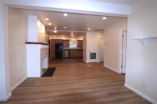 kitchen with black fridge, stainless steel dishwasher, dark hardwood / wood-style floors, and sink