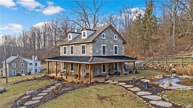 farmhouse-style home featuring a patio area and a front yard