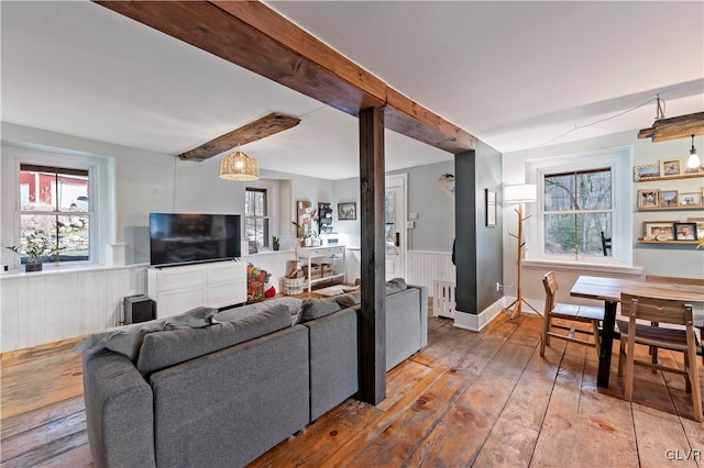 living room with hardwood / wood-style flooring and beamed ceiling