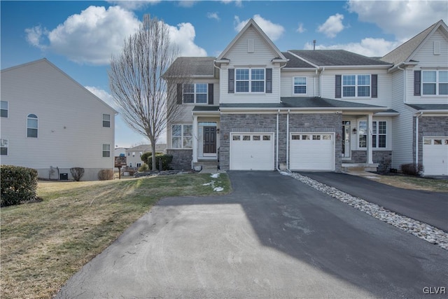 view of front of property featuring a garage and a front lawn