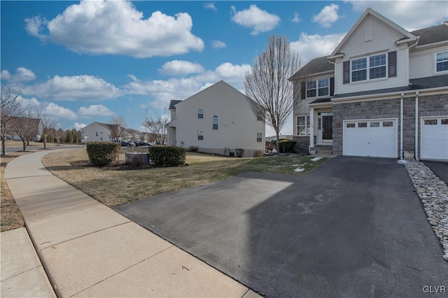 view of front of property with a garage and a front lawn