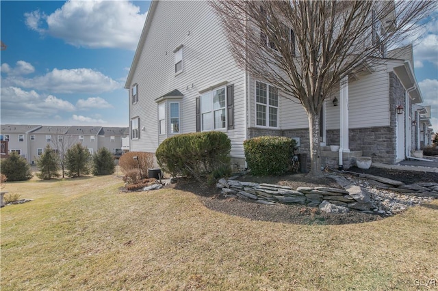 view of property exterior featuring cooling unit and a lawn