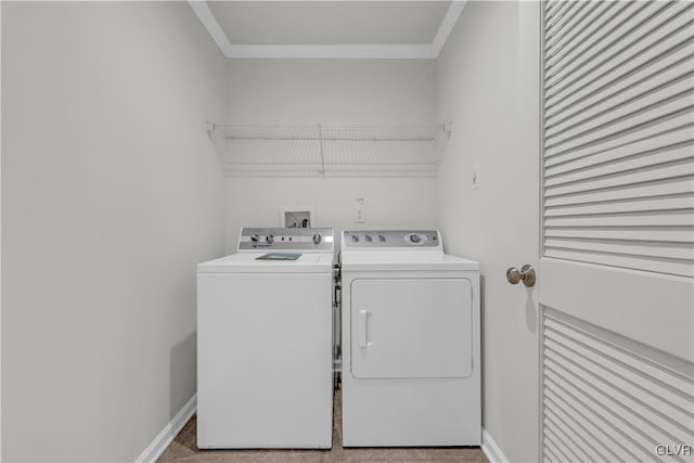 clothes washing area featuring ornamental molding and washer and dryer