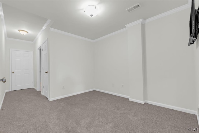 spare room featuring crown molding and carpet