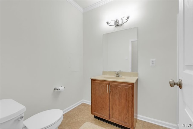 bathroom with vanity, crown molding, and toilet