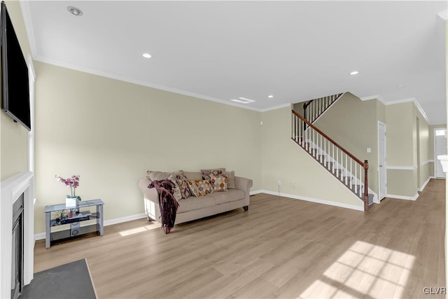 sitting room with light hardwood / wood-style flooring and ornamental molding