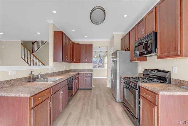 kitchen featuring ornamental molding, sink, light wood-type flooring, and black appliances