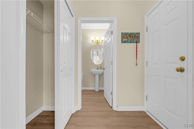 hall featuring sink and light hardwood / wood-style flooring