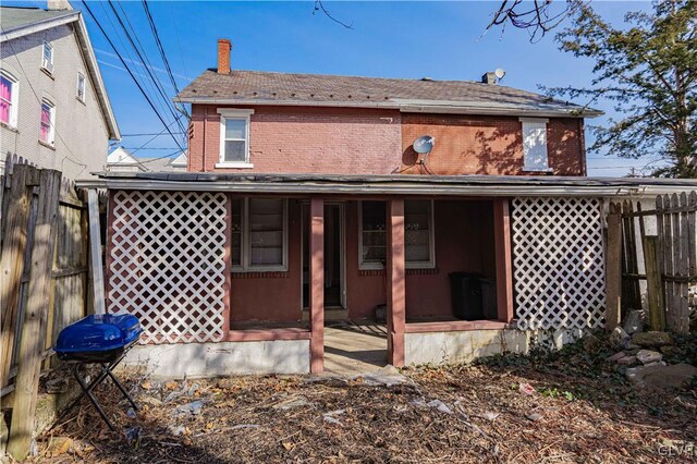 back of house featuring a porch