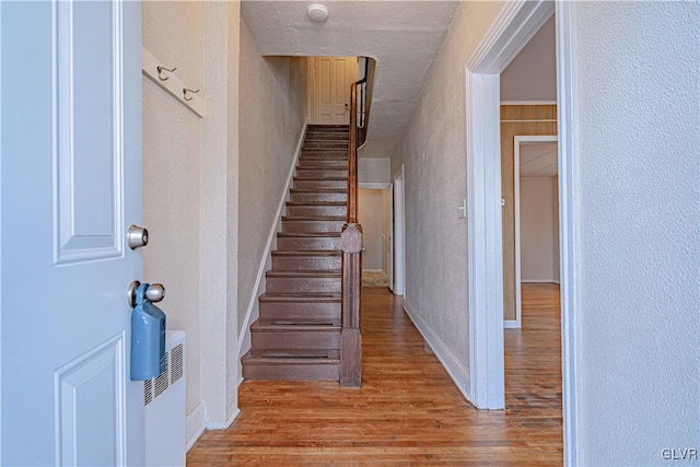 staircase featuring hardwood / wood-style flooring