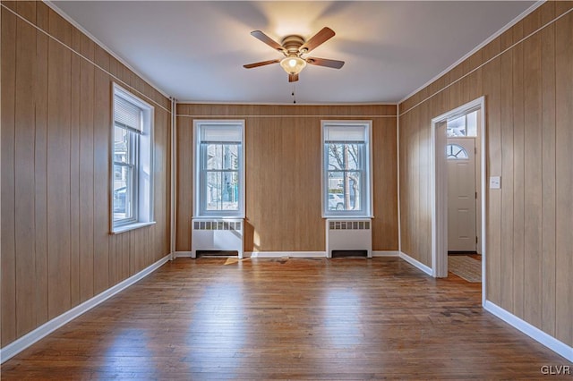 entrance foyer featuring hardwood / wood-style flooring, radiator, and ceiling fan