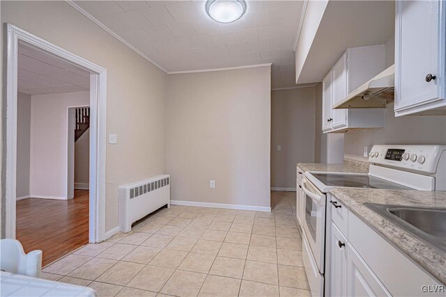 kitchen with white cabinetry, light tile patterned floors, ornamental molding, radiator heating unit, and white electric stove