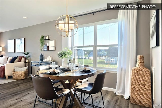 dining space featuring dark hardwood / wood-style floors and a notable chandelier