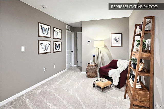 sitting room featuring light carpet