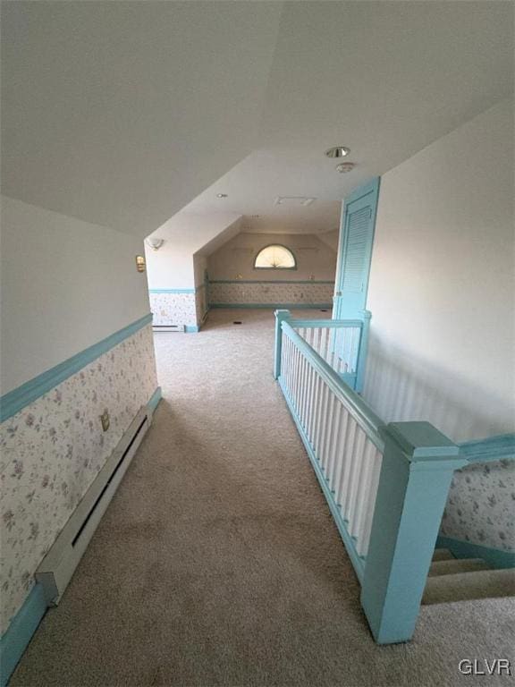 corridor featuring a baseboard radiator and carpet floors