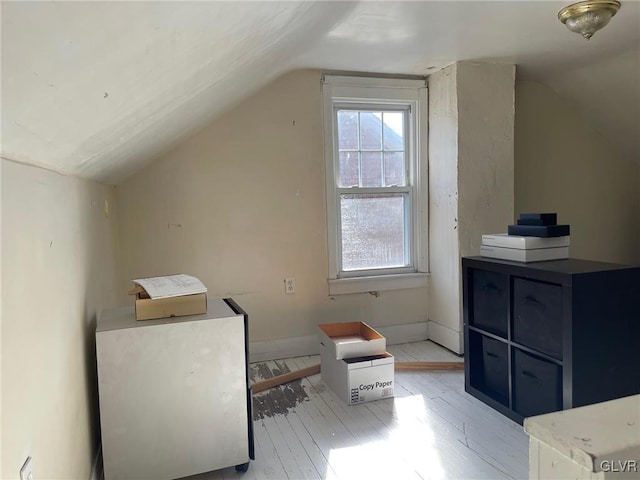 bonus room with vaulted ceiling and light hardwood / wood-style floors