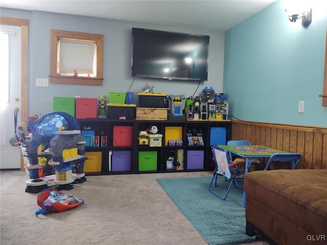 recreation room featuring light colored carpet