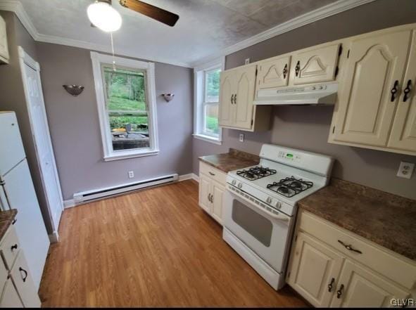 kitchen featuring white range with gas stovetop, light hardwood / wood-style flooring, a baseboard radiator, ornamental molding, and ceiling fan