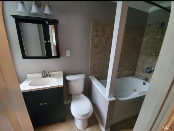 full bathroom with tiled shower / bath, vanity, and toilet