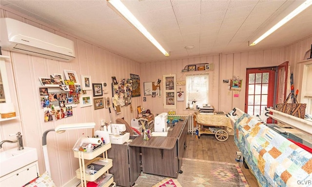 office space featuring wood-type flooring and a wall unit AC