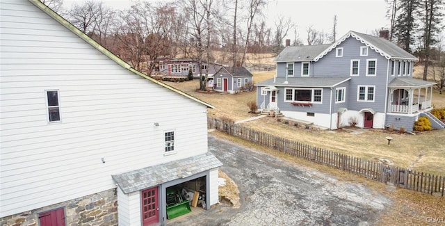 view of side of home with a garage and covered porch