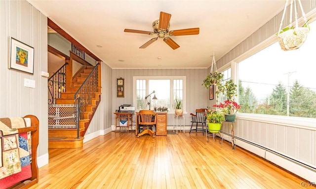 office space featuring hardwood / wood-style flooring, a healthy amount of sunlight, and baseboard heating