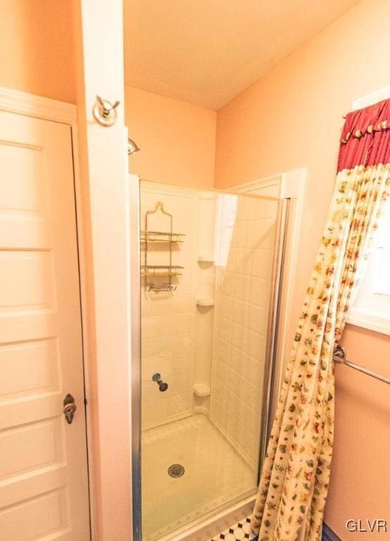 bathroom with tiled shower