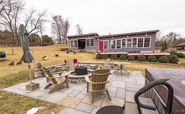 view of patio / terrace with a wooden deck and a fire pit