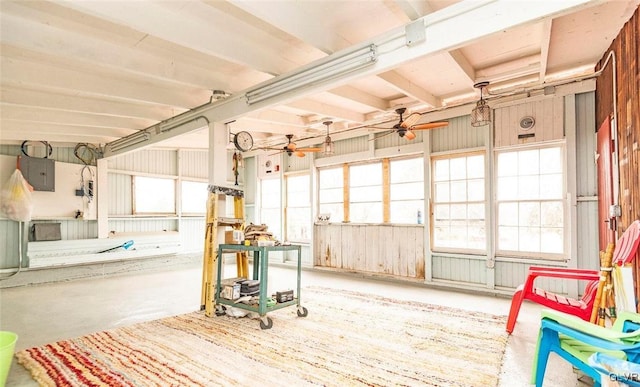 misc room featuring plenty of natural light, electric panel, concrete floors, and ceiling fan