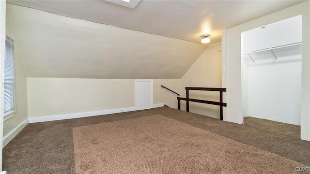 bonus room with carpet flooring and vaulted ceiling