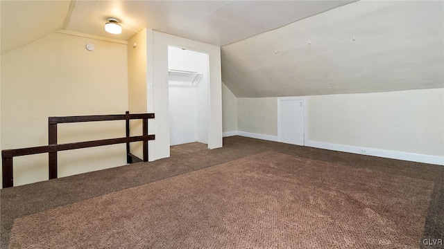 bonus room with vaulted ceiling and carpet floors