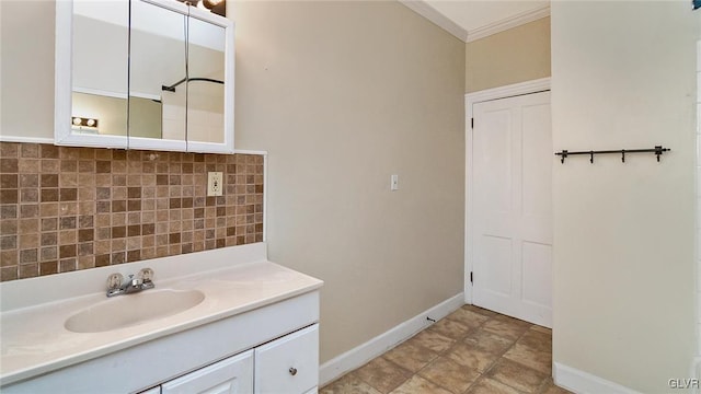 bathroom with tasteful backsplash, vanity, and ornamental molding