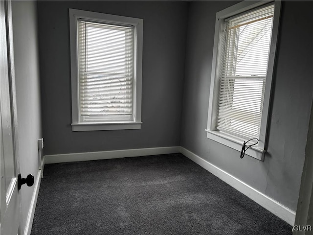 empty room with dark colored carpet