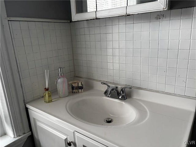 bathroom with vanity and tile walls