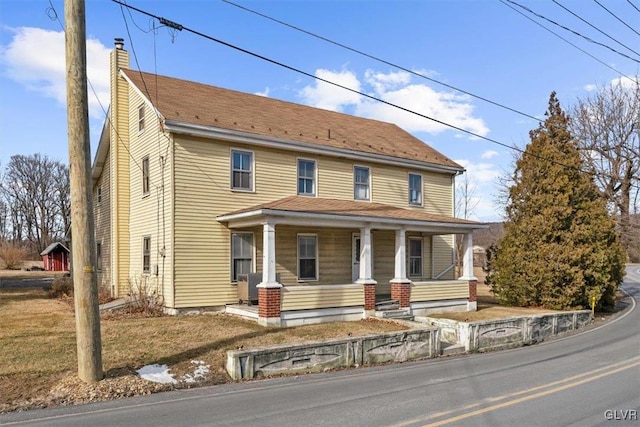 view of front of house featuring cooling unit and covered porch